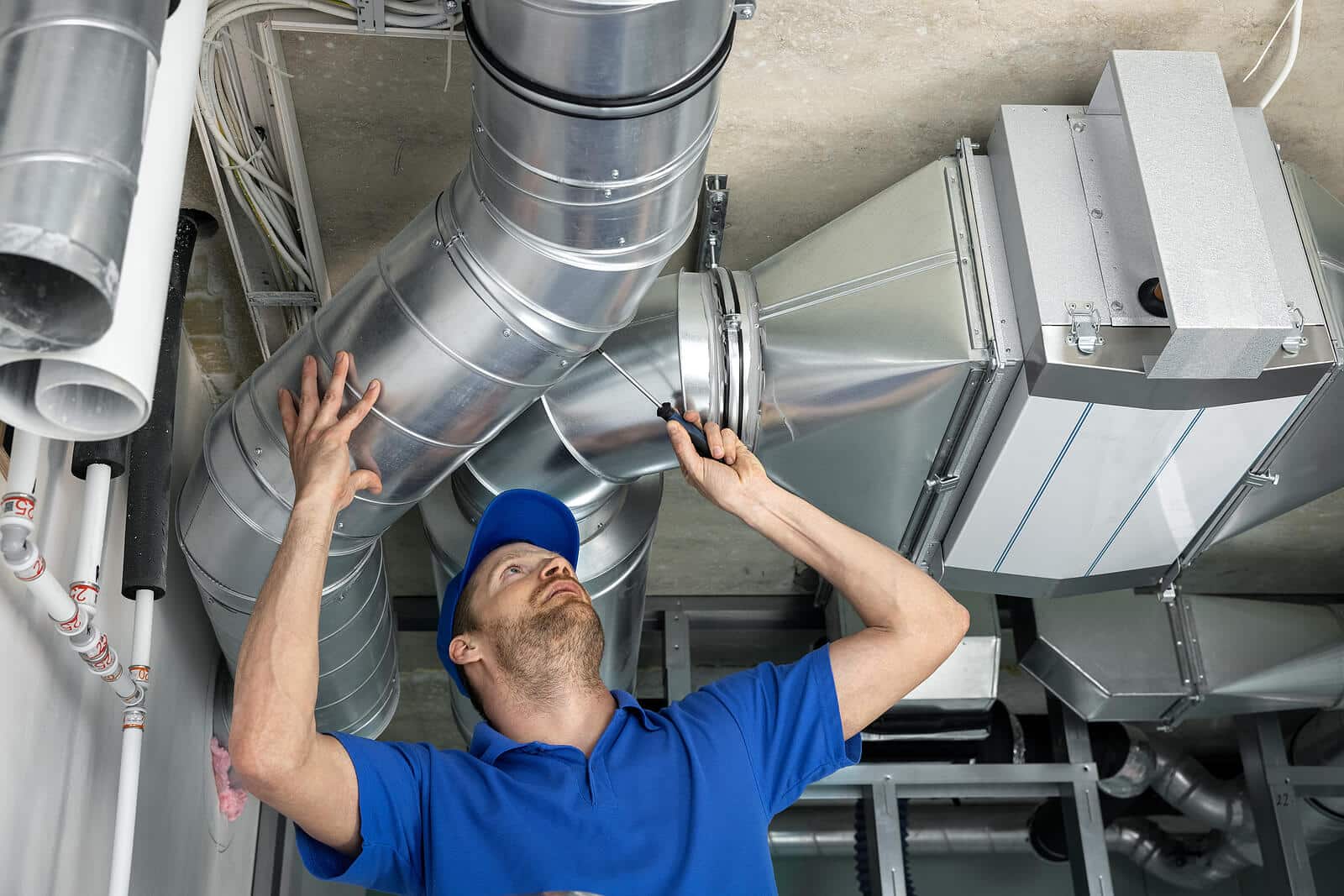 HVAC technician inspecting and repairing air ducts in Simi Valley