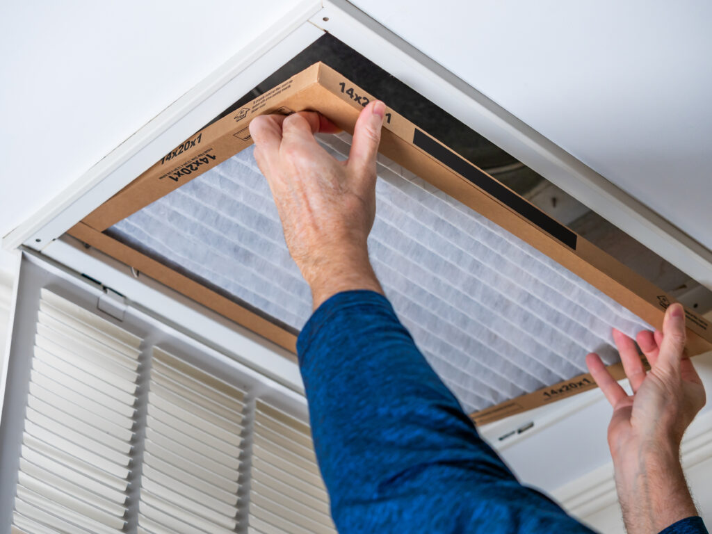 HVAC technician replacing a home air filter in Simi Valley