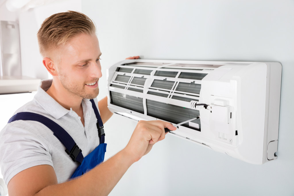HVAC technician maintaining a ductless air conditioner in Simi Valley
