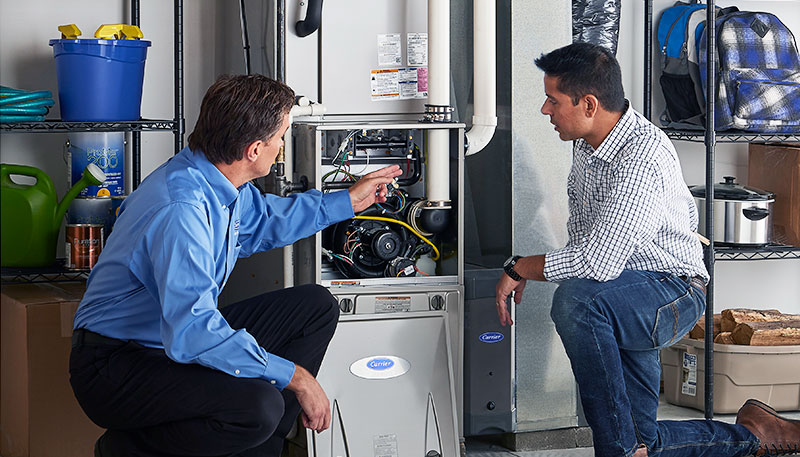 Technician evaluating a furnace for repair or replacement in Simi Valley