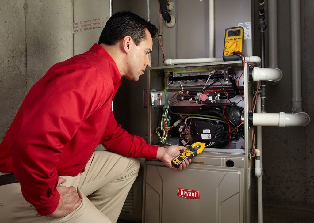 Heating technician diagnosing a furnace repair in Simi Valley