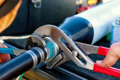 Technician repairing an industrial pipe connection in Simi Valley