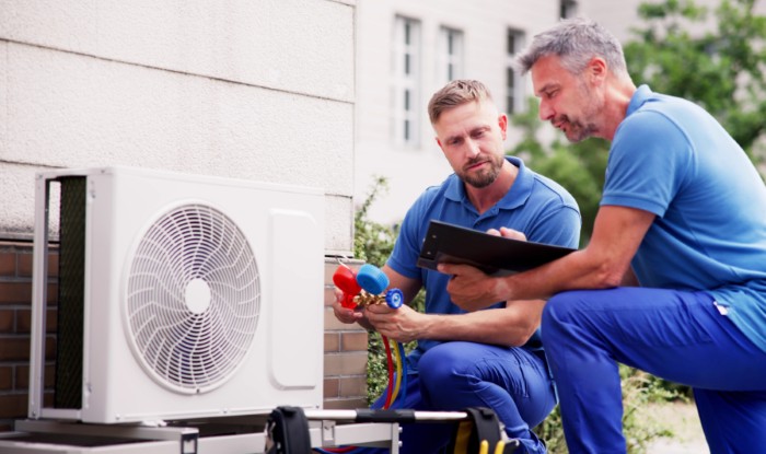 HVAC technicians installing an outdoor air conditioning unit in Simi Valley