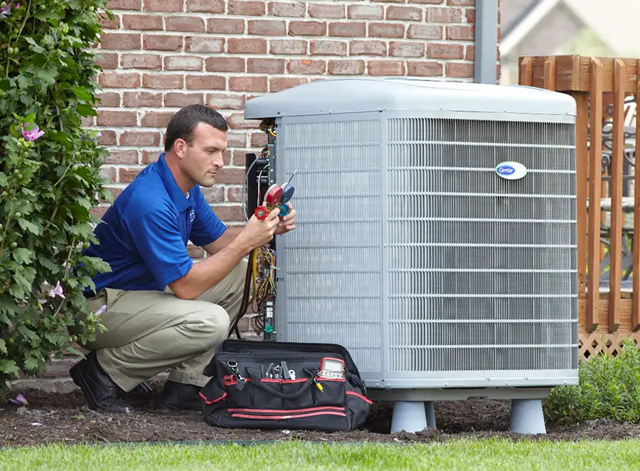 HVAC technician inspecting an outdoor AC unit in Simi Valley